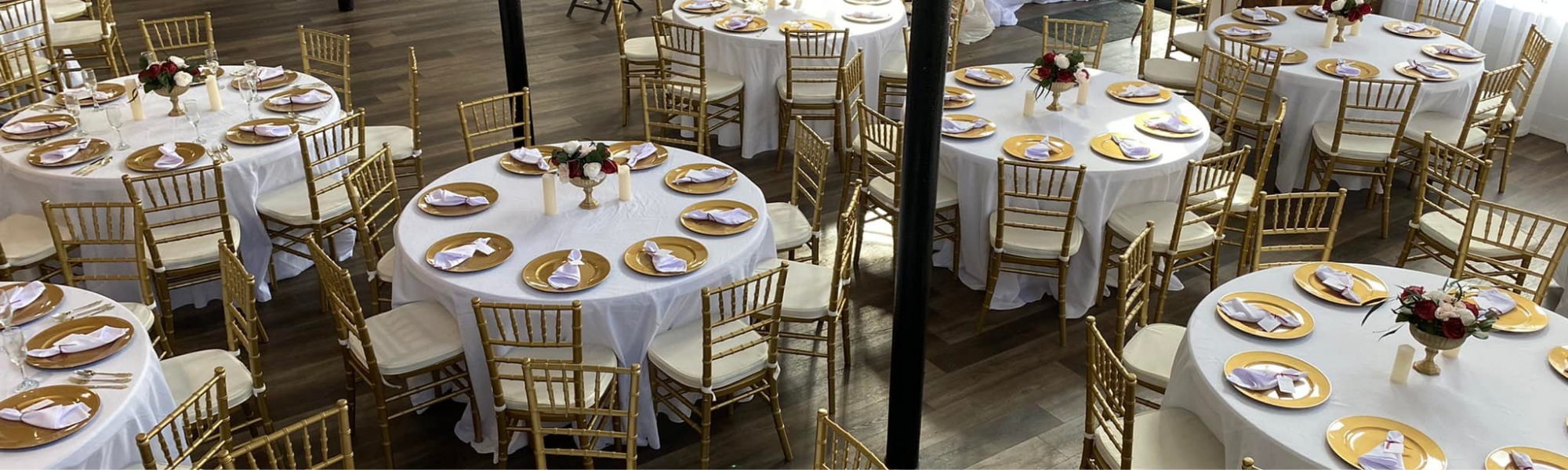 beautiful reception tables with gold chairs and plates